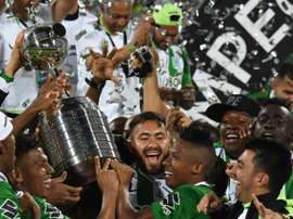Colombias Atletico Nacional players celebrate with the trophy after winning the 2016 Copa Libertadores at Atanasio Girardot stadium