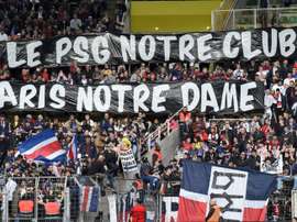 PSG supporters with the banner in respect to the fire. AFP