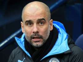 Pep Guardiola reassured fans that he'll stay at Man C. AFP