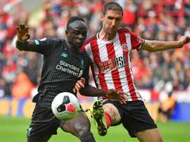 Chris Basham (R) believes the five subs rule will be bad for Sheff Utd. AFP