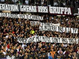 Metz supporters hold banners that got their match with PSG halted for three minutes. AFP