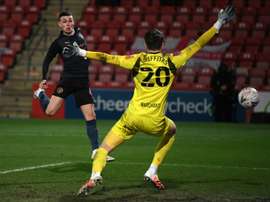 Manchester City midfielder Phil Foden (left) scores against Cheltenham. AFP