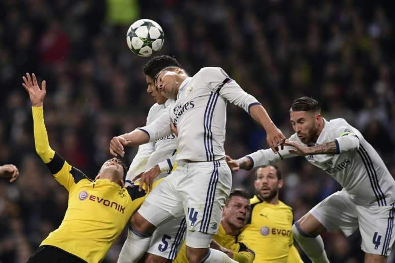 Dortmund and Real Madrid players clash during the match at the Santiago Bernabeu stadium in Madrid on December 7, 2016