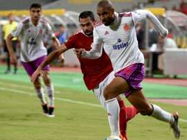 Al-Ahlys Ahmed Fathi (L) marks Wydads Ismail El Haddad during their CAF Champions League match. AFP