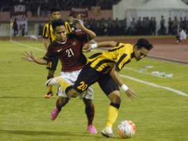 Indonesias Andik Vermansyah (back) challenges Mohd Azrif Nasrulhaq Badrul Hisham of Malaysia during their friendly football match in Solo on September 6, 2016