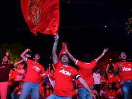 Supporters of Manchester United cheer during a match in New Delhi on May 17, 2015