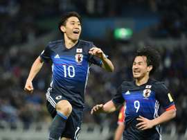 Japan forward Shinji Kagawa (left) celebrates a goal against Syria in Saitama on March 29, 2016