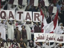 Qatari fans hold banners to show their support for their national team during the group B 2014 World Cup Asian qualifying football match between Qatar and South Korea in Doha on June 8, 2012
