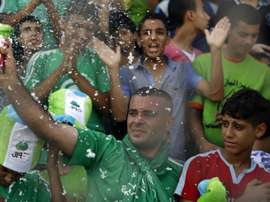 Palestinian spectators cheer during a football match between the West Bank-based Al-Ahli and Gazas Shejaiya, playing each other for the first time in 15 years, at the al-Yarmuk stadium in Gaza City on August 6, 2015