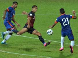Guam forward Marcus Lopez is challenged by Indias Narayan Das (right) and Arnab Kumar Mondal during their Asia Group D 2018 World Cup qualifying match in Bangalore on November 12, 2015