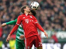 Bremen's Thomas Delaney and Bayern Munich's Thomas Mueller try to head the ball. AFP