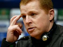 Neil Lennon was struck by objects thrown by the crowd. AFP