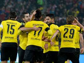 Dortmund players celebrate after they score the opening goal during the German Cup quarter final football match at VfB Stuttgart on February 9, 2016