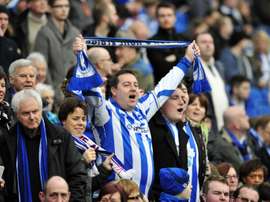Brighton & Hove Albions fans sing in the crowd ahead of a match in Brighton, southern England on January 5, 2013
