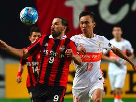 FC Seoul forward Dejan Damjanovic (left) fights for the ball with Shandong Luneng's Zhang Chi. AFP