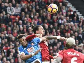 Zlatan Ibrahimovic clashes in the air with Bournemouths defender Tyrone Mings. AFP