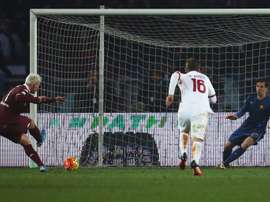 Torinos forward Maxi Lopez (L) kicks and scores a penalty against Romas goalkeeper Wojciech Szczesny during an Italian Serie A football match on December 5, 2015 at the Olympic Stadium in Turin