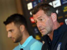 Andreas Samaris (L) rejoins the Greek national football team in the line up announced by head coach Michael Skibbe (R)tain Andreas Samaris (L) attend a press conference in Sydney on June 3, 2016.Australia play Greece in a double-header football international friendlies in Sydney on June 4 and in Melbourne on June 7.