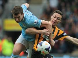 Hull Citys English defender James Chester (right) vies with Manchester Citys Bosnian striker Edin Dzeko during their English Premier League match at the KC Stadium in Hull on March 15, 2014