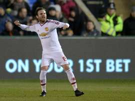 Manchester Uniteds midfielder Juan Mata celebrates scoring his teams second goal during the English FA Cup fifth round football match between Shrewsbury Town and Manchester United in Shrewsbury, England on February 22, 2016