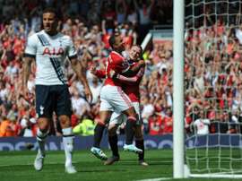 Manchester Uniteds Memphis Depay (2nd right) celebrates with Wayne Rooney (right) after United take the lead due to an own goal from Tottenham Hotspurs Kyle Walker at Old Trafford on August 8, 2015