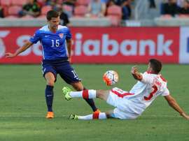 Giuliano Frano (R) of Canada directs the ball away from Marc Pelosi of the US during the first half of the third place CONCACAF Olympic qualifying match, at Rio Tinto Stadium in Sandy, Utah, on October 13, 2015