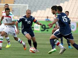 Guams player Jason Cunliffe (C) is challenged by Iranian players during a qualifying match for the 2018 FIFA World Cup at the Azadi stadium in Tehran on September 3, 2015