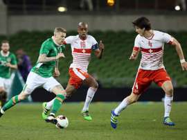 Republic of Irelands midfielder James McClean (L) runs with the ball as Switzerlands midfielder Gelson Fernandes and defender Timm Klose (R) defend during the friendly football match in Dublin on March 25, 2016