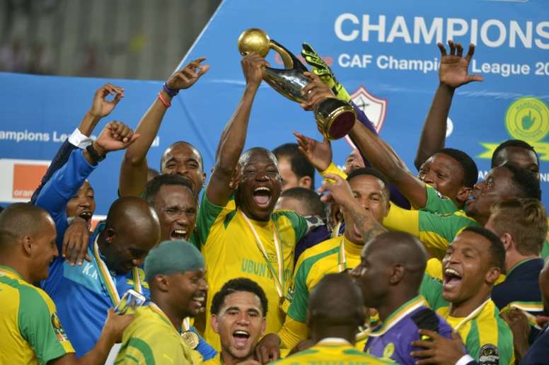 Mamelodi Sundowns players celebrate with the trophy after winning the CAF Champions League football competition following the final match against Egypts Zamalek on October 23, 2016