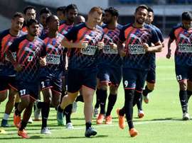 Delhi Dynamos FC players warm up during a training session at the Jawaharlal Nehru Stadium in New Delhi on September 30, 2015
