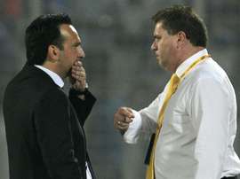 Bangladesh football coach Fabio Lopez (L) talks to Australias football coach Ange Postecoglou in Dhaka on November 17, 2015