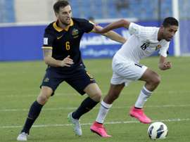 Jordans Hasan Abdel-Fattah (C) dribbles past Australias Matthew Spiranovic during the AFC qualifying football match for the 2018 FIFA World Cup on October 8, 2015 at the Amman International Stadium in the Jordanian capital