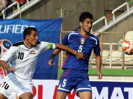 Younis Mahmoud (left) rescued a point for Iraq with a last-ditch penalty as the former Asian champions drew 1-1 with Vietnam in Hanoi