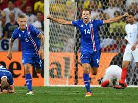 (L to R) Icelands defender Ragnar Sigurdsson and teammate Kari Arnason celebrate their teams 2-1 win in a Euro 2016 round of 16 football match against England at the Allianz Riviera stadium in Nice on June 27, 2016