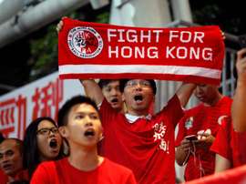 Hong Kong football fans cheer for their team during the World Cup qualifier against China at Hong Kongs Mong Kok Stadium on November 17, 2015