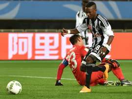 Rainford Kalaba (front) tries to pick up the ball following his goal against Club America. AFP