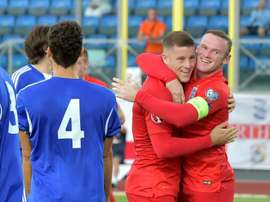 Englands Ross Barkley (C) celebrates with Wayne Rooney (R) after soring during a Euro 2016 qualifying football match against San Marino in Serravalle on September 5, 2015