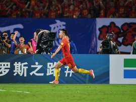 Gao Lin celebrates scoring a goal against Uzbekistan. AFP