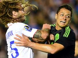 Javier Hernandez (R) of Mexico collides with Kyle Beckerman of the US during their CONCACAF Cup match at the Rose Bowl in Pasadena, California, on October 10, 2015