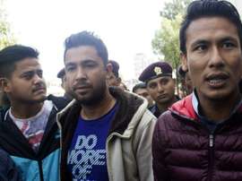 Nepalese footballers Sagar Thapa (R), Ritesh Thapa (C) and Sandip Rai (L) arrive at a Special Court in Kathmandu on October 27, 2015 as part of the match-fixing scandal that has hit the national team