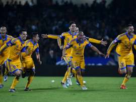 Tigres forward Andre-Pierre Gignac (R) celebrates with teammates after defeating the Pumas in penalties during their Mexican Apertura match on December 13, 2015 in Mexico City
