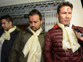Nepalese footballers Sagar Thapa (R), Anjam KC (C) and Bikash Singh Chhetri (L) talk with the media outside a special court in Kathmandu on November 10, 2015