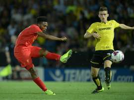 Liverpools striker Daniel Sturridge (L) shoots but sees his shot saved. AFP