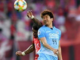 Paulinho rises to beat Tsubasa. AFP