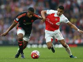 Manchester Uniteds midfielder Antonio Valencia (L) clashes with Arsenals striker Alexis Sanchez during an English Premier League football match at the Emirates Stadium in London on October 4, 2015