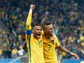 Brazils Luan (R) celebrates with teammate Neymar after scoring a goal against Colombia during their Rio 2016 Olympic Games quarter-final match, at the Corinthians Arena in Sao Paulo, on August 13