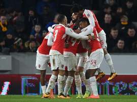 Arsenals midfielder Theo Walcott celebrates with teammates after scoring their third goal during the FA cup fifth round replay football match between Hull City and Arsenal in Kingston upon Hull in north east England on March 8, 2016