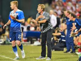USA national team coach Juergen Klinsmann (C) shouts instructions to his players as Tim Ream prepares to a throw-in, during their intl friendly against Peru, at RFK Stadium in Washington, DC, on September 4, 2015