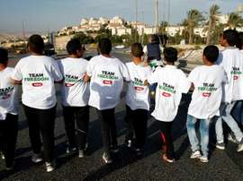 Palestinian youths wanting to play football in the Maale Adumim settlement in the Israeli occupied West Bank march as they try to enter the settlement on October 11, 2016