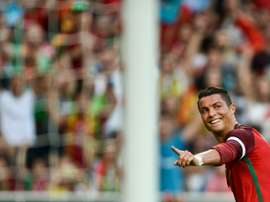 Portugals forward Cristiano Ronaldo celebrates after scoring against Estonia during the friendly football match Portugal vs Estonia at Luz stadium in Lisbon on June 8, 2016, in preparation for the upcoming UEFA Euro 2016 Championship